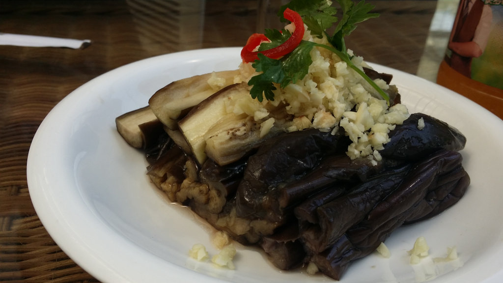 Aubergine covered in grated garlic