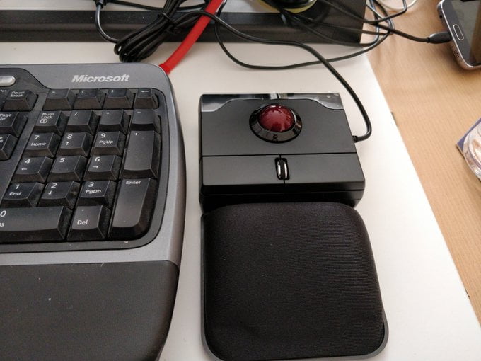 A red trackball set in black plastic.