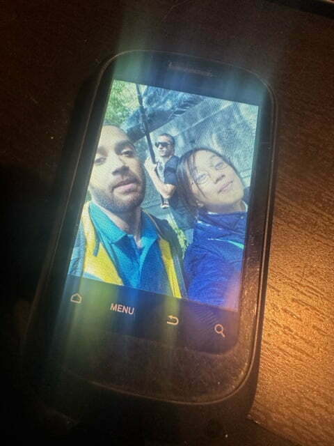 Photo of a phone showing a selfie.