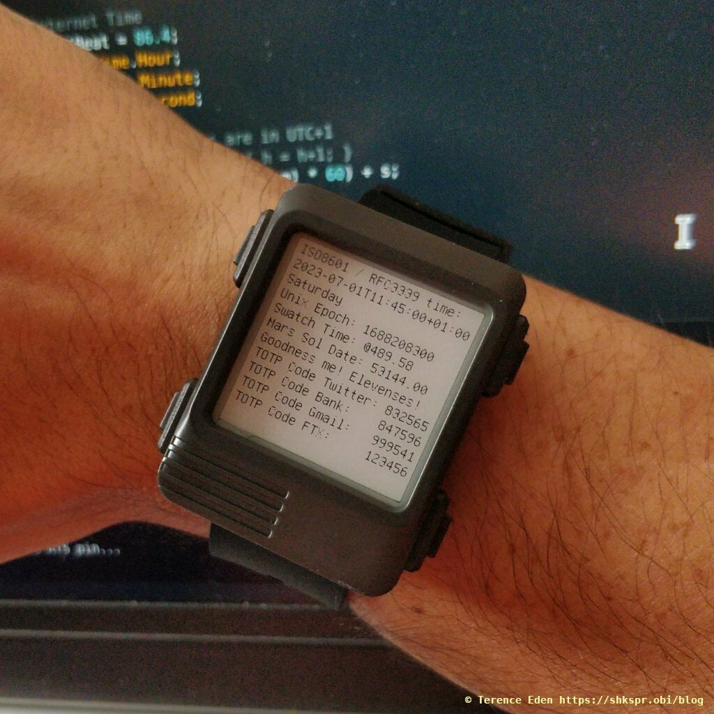 A chunky wristwatch showing the time and a selection of 6 digit codes and their corresponding entities.