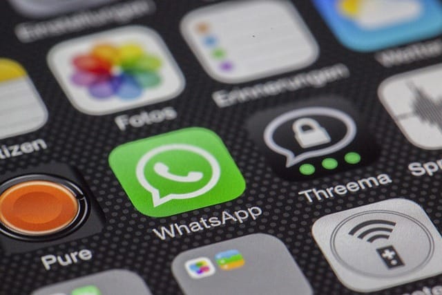 WhatsApp logo on a phone.